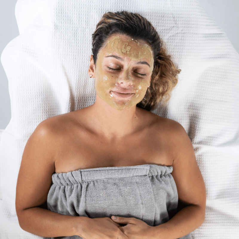 Woman with facial treatment product on face