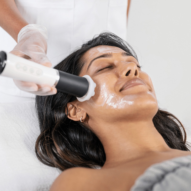 Woman receiving a Geneo facial treatment