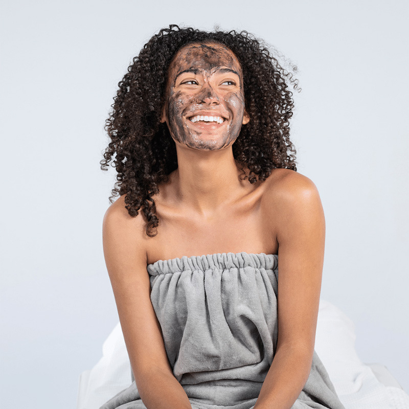 Woman with Geneo facial treatment product on her face