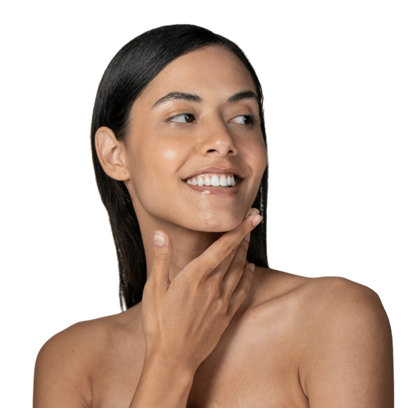 Woman with dark, straight hair gently touching her face, smiling, and looking off to the side