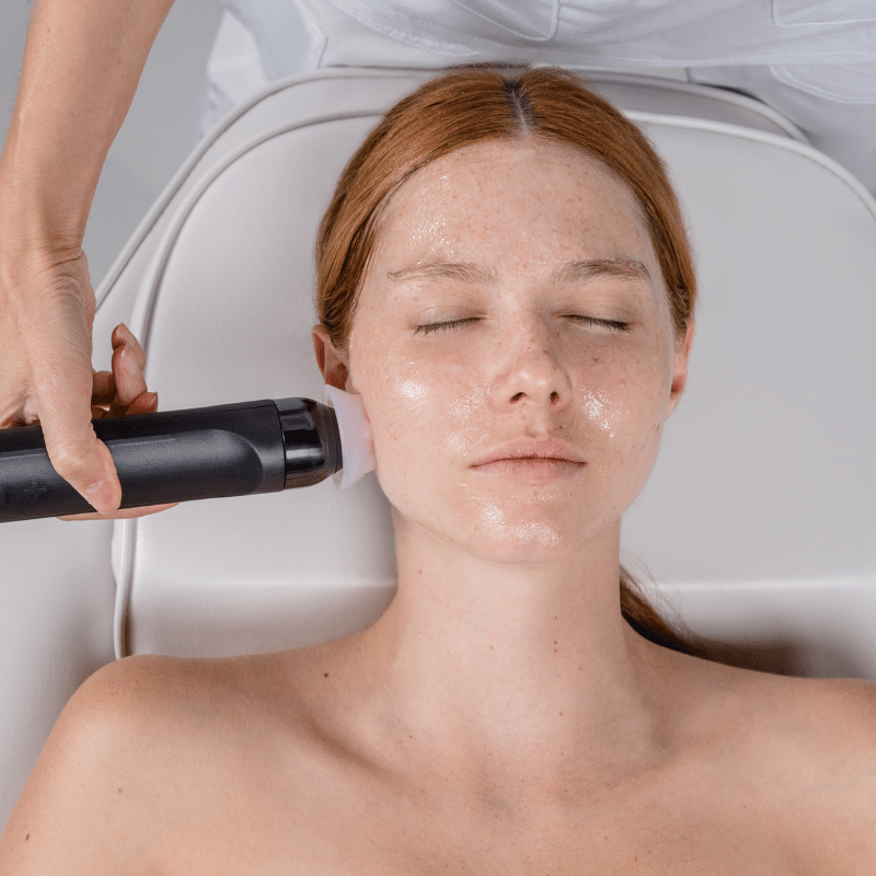 Woman receiving facial treatment with Geneo X facial machine