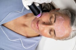 Older woman receiving anti-aging skin care treatment